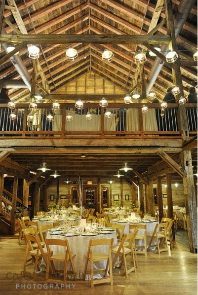 Upper and lower levels of reception area of Pat's Barn with decorations and tables.